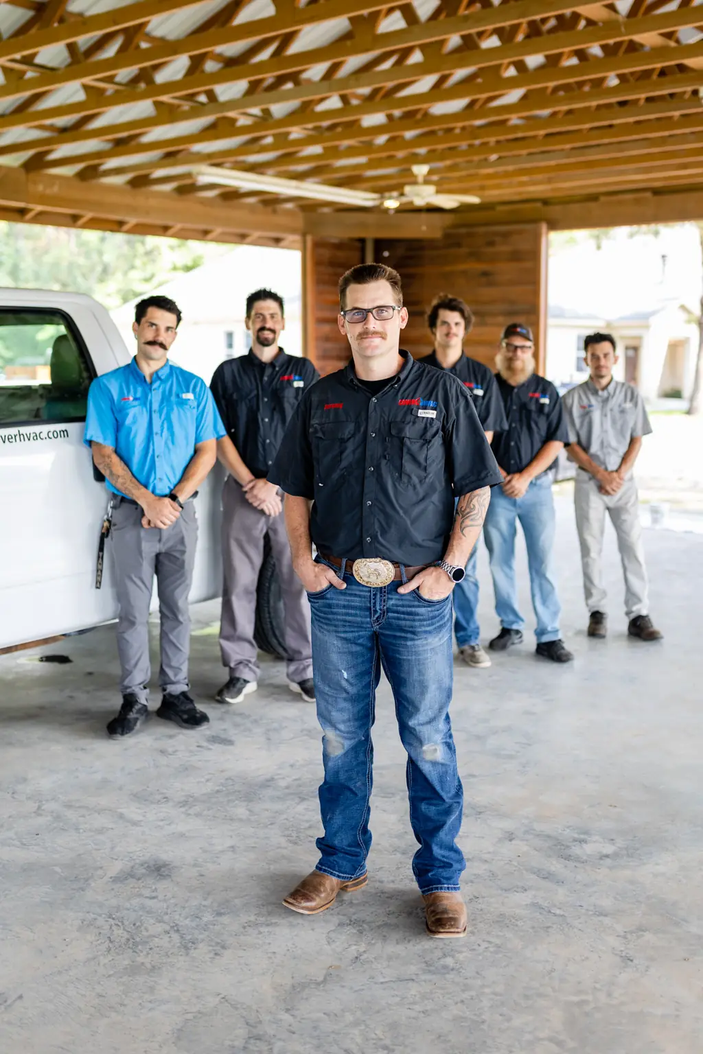 Jeremy Cover standing with the Cover HVAC crew in front of a company truck